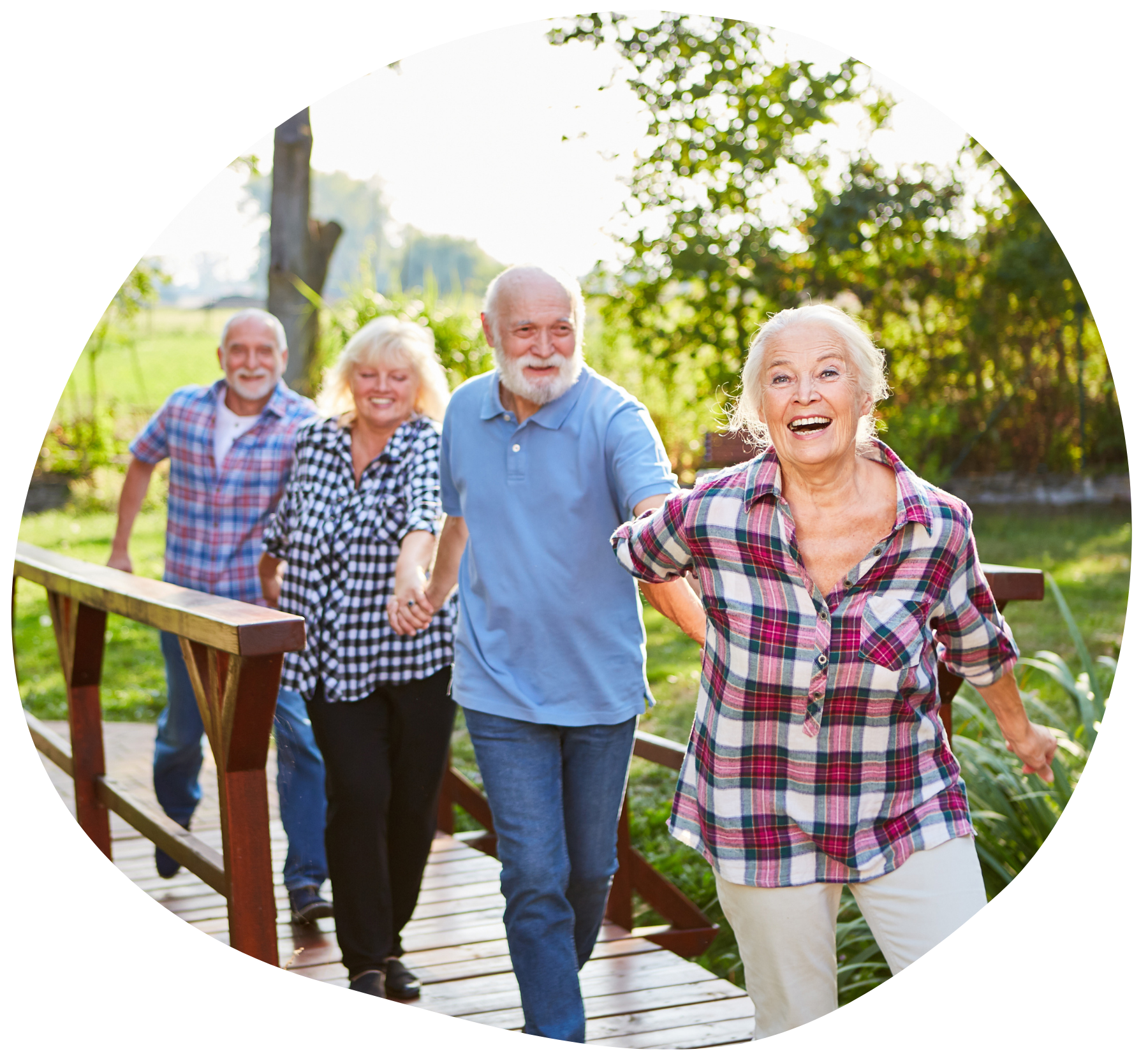 A group of smiling older adults crossing a bridge